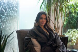 woman enjoying a relaxing water wall thinking about spa etiquette